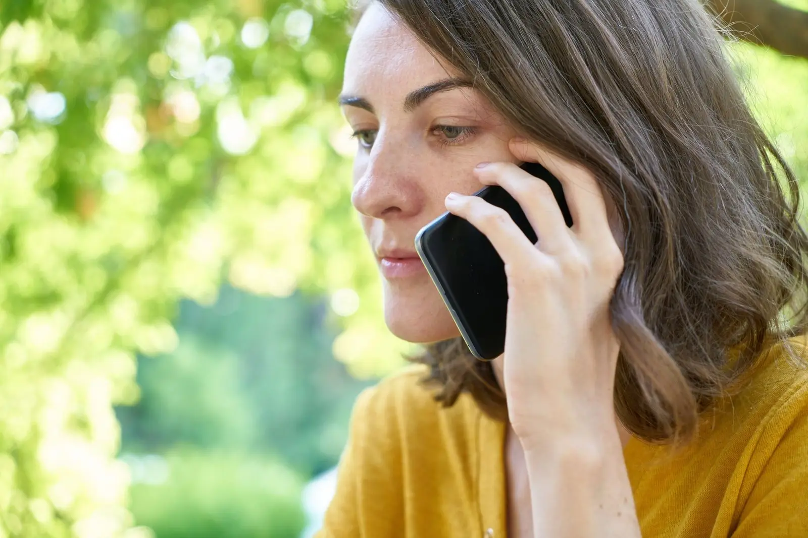A woman talking on a mobile phone outdoors