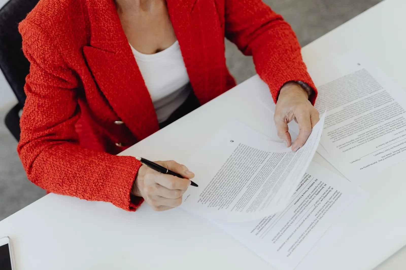 Woman reading and marking a set of printed documents