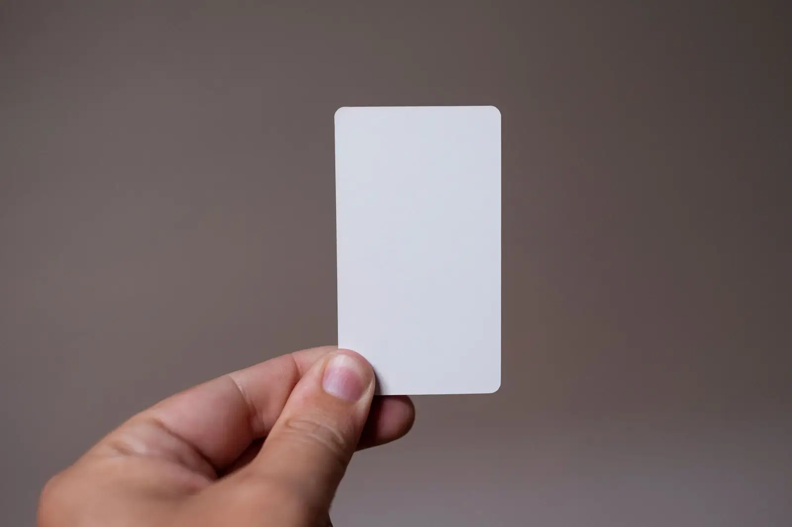 Hand holding up a blank card