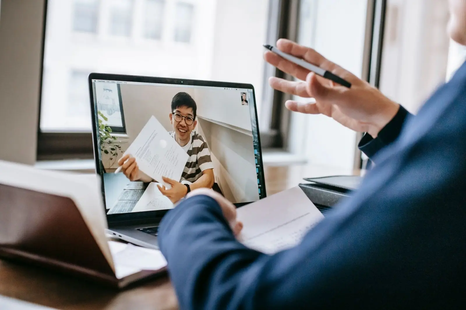 Video call where one person holds up a document to the camera