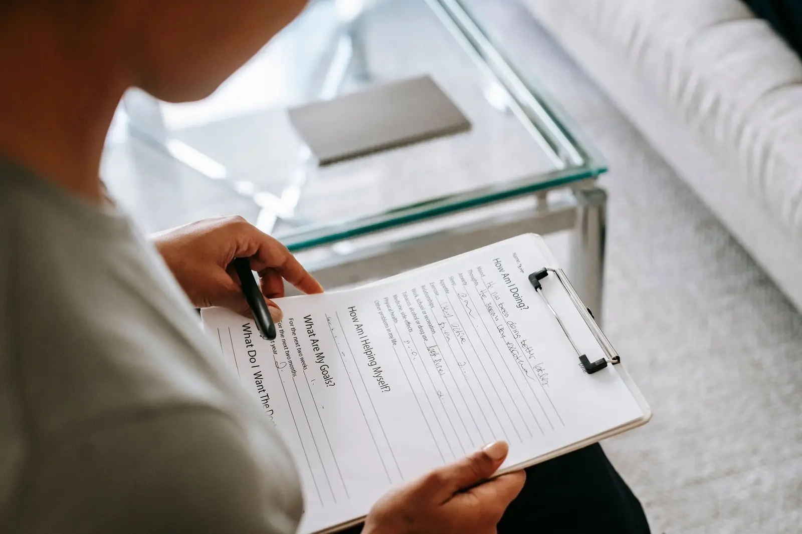 A person holding a clipboard with a printed form